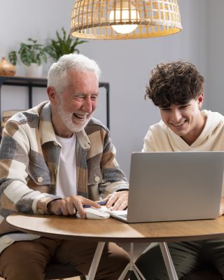 medium-shot-kid-grandfather-with-laptop