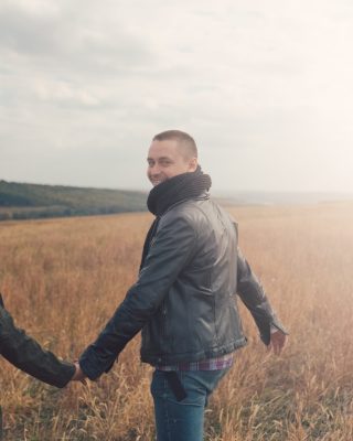 Young modern stylish couple outdoors. Romantic young couple in love outdoors in the countryside